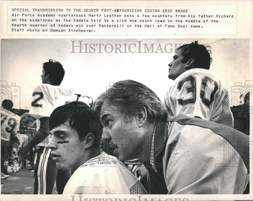 Marty Louthan gets pointer from father at sidelines - Historic Images