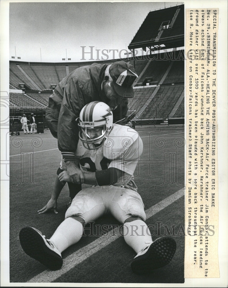 Press Photo Trainer Jim Conboy attends to Air Force Running Back John Kershner. - Historic Images