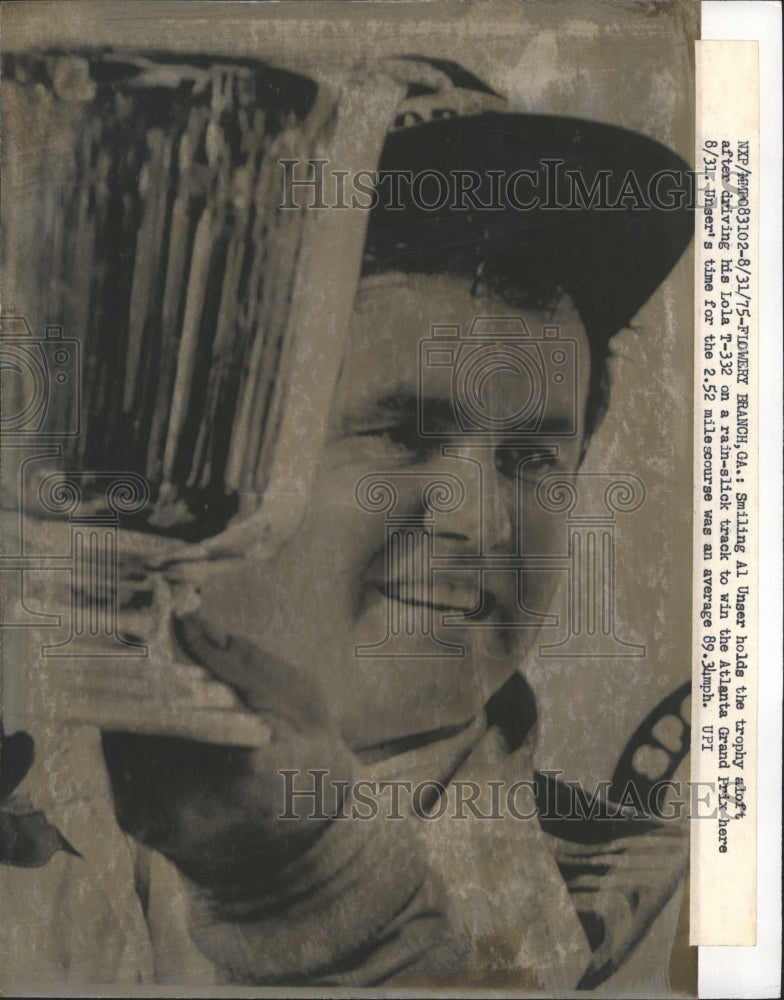 1975 AL Unser after racing holding Trophy-Historic Images