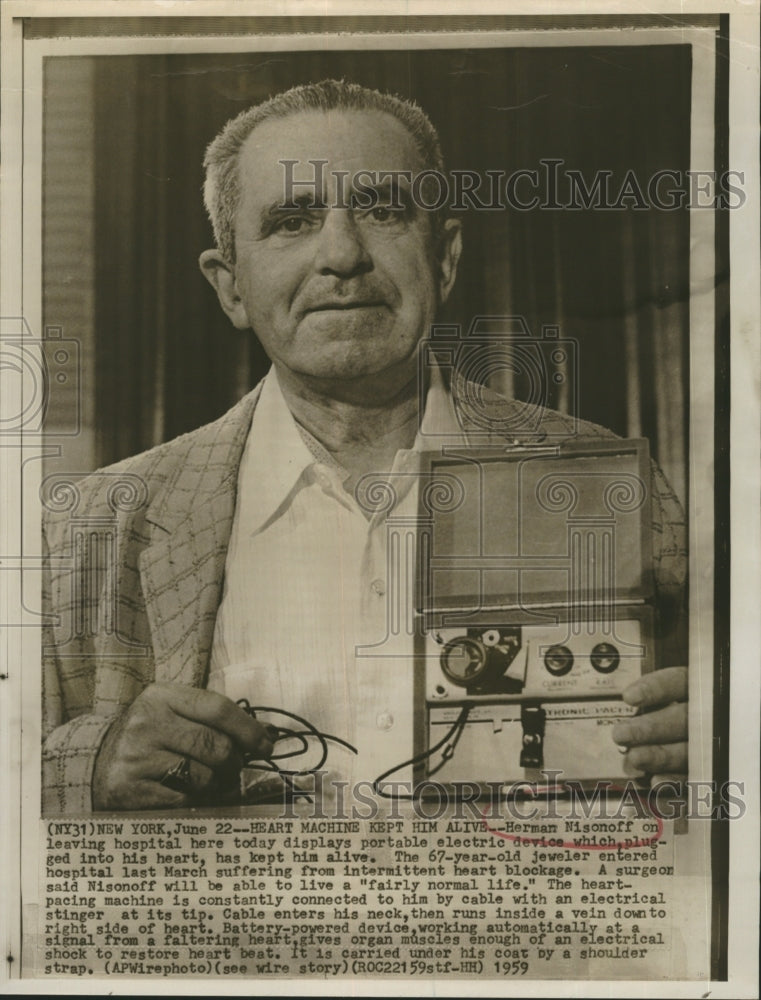 1959 Press Photo Herman Misonoff displays portable electric device - RSH38339 - Historic Images