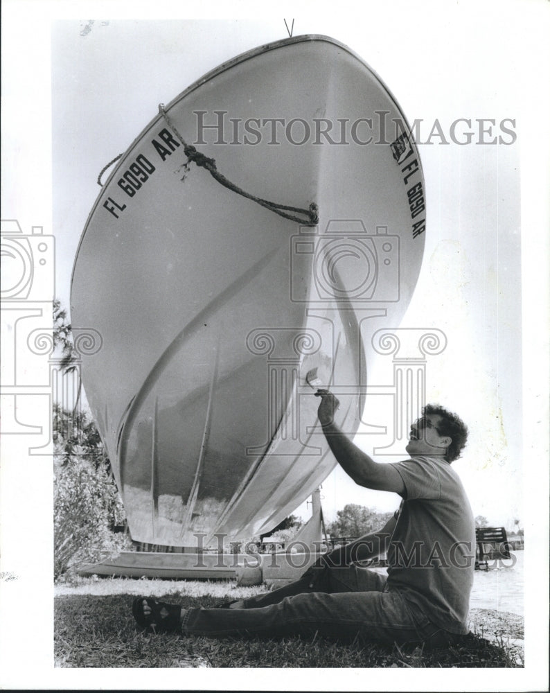 1985 Press Photo Ted Marquaret is putting primer on his boat - Historic Images