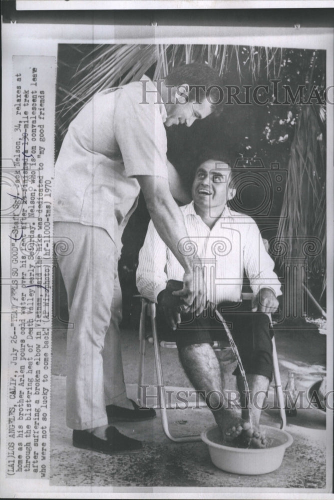 1970 Press Photo Staff Sgt. Jack Nelson relaxes as hir brother pours cold water - Historic Images