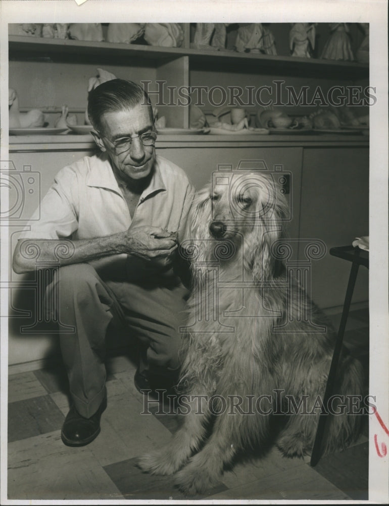 1956 Kasha the dog refuses her biscuit while hamming for the camera - Historic Images