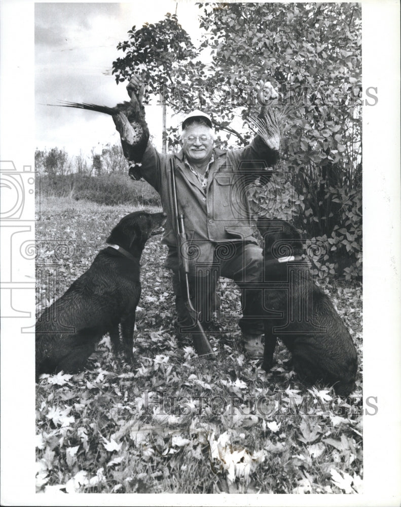 1989 Hunter Al Lesh of Warren catches 2 rooster pheasants - Historic Images