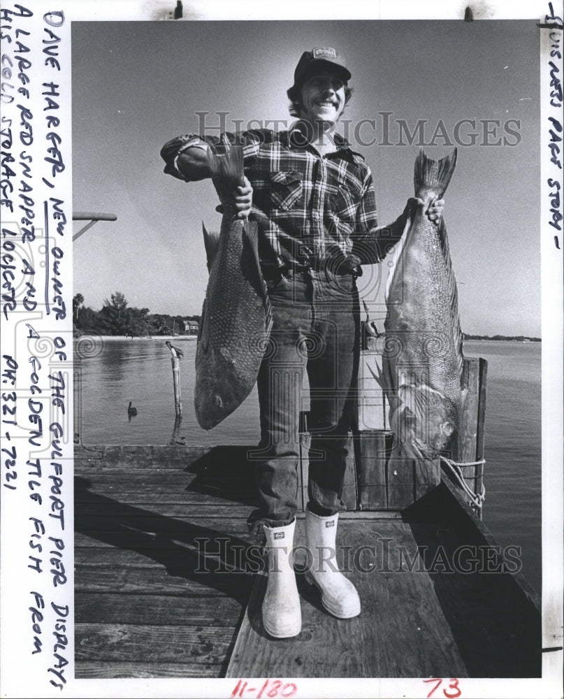 1980 Dave Harger, New Owner of the Gulfport Pier, shows some catches - Historic Images