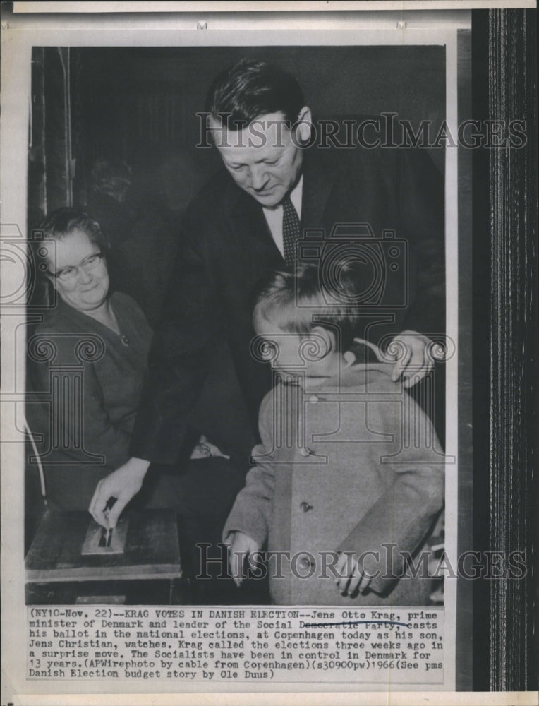 1966 Jens Otto Krag casts his ballot with son Jens Christian. - Historic Images