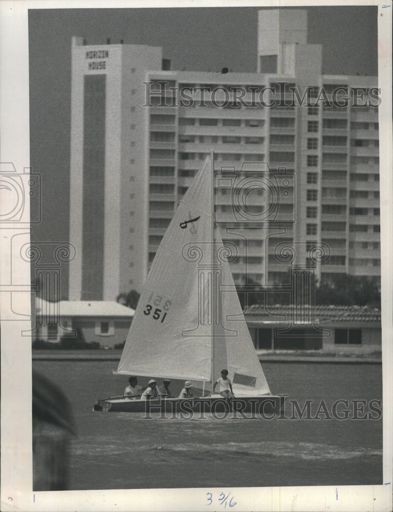 1972 Sailboat glides by in Clearwater Bay with five sailors aboard - Historic Images