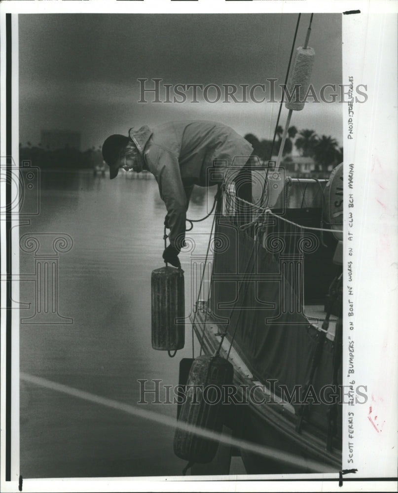 1980 Scott Ferris Adjusts Bumpers on Boat at Clearwater Beach - Historic Images