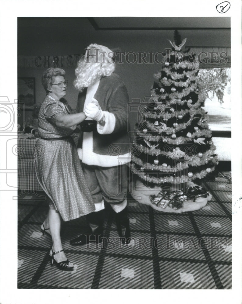 1988 Peggy Norris dances with Santa.  - Historic Images