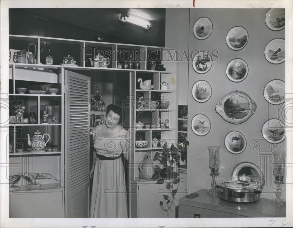 Mrs. Stanley G. May takes one final look at her dining room. - Historic Images