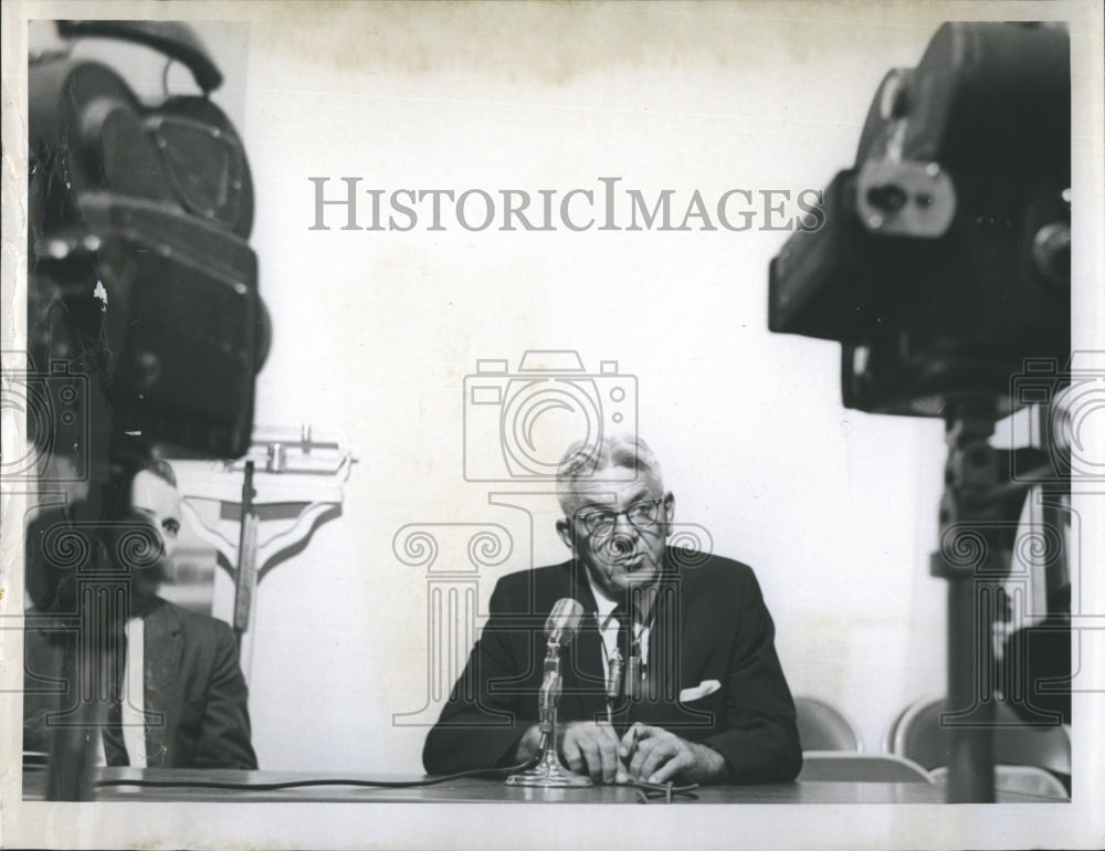 Dr. Harry Oard at press conference.  - Historic Images