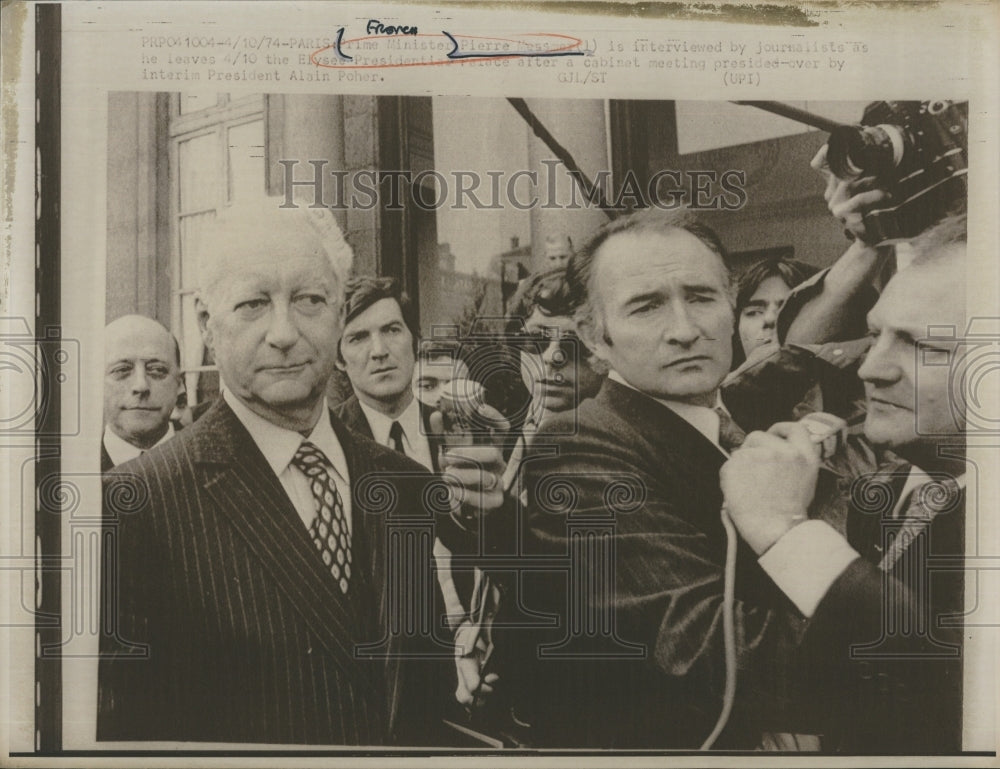 1974 Prime Minister Pierre Messmer of France surrounded by newsman. - Historic Images