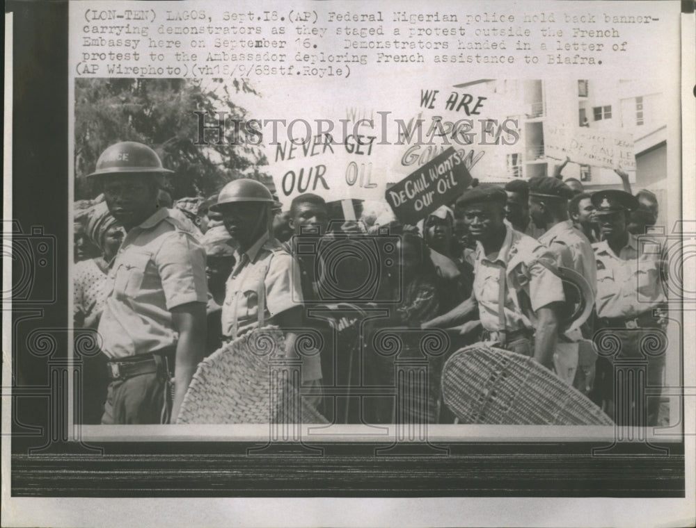 1968 Nigerian police hold back demonstrators on the streets of Lagos - Historic Images