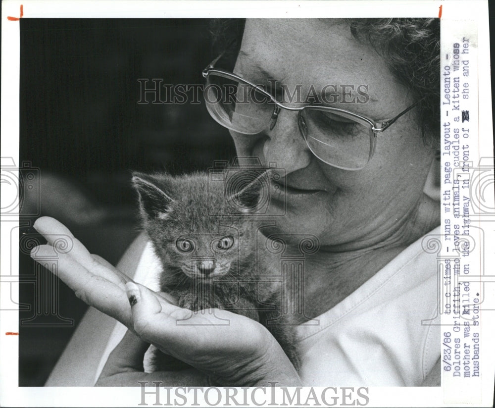 1986 Delores Griffith holds a kitten.  - Historic Images
