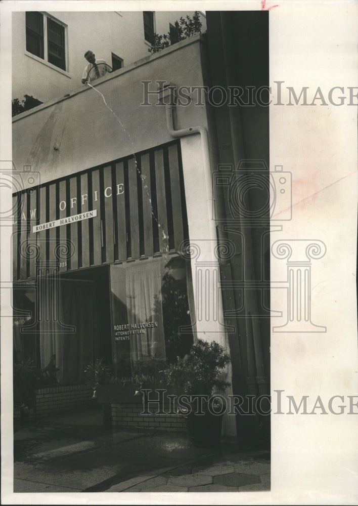 1965 Attorney Robert Halverson watering plants on roof of building - Historic Images