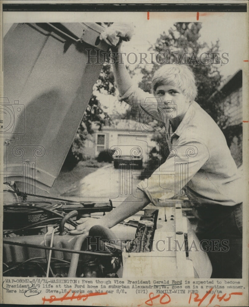 1974 Steve Ford works on his car - Historic Images