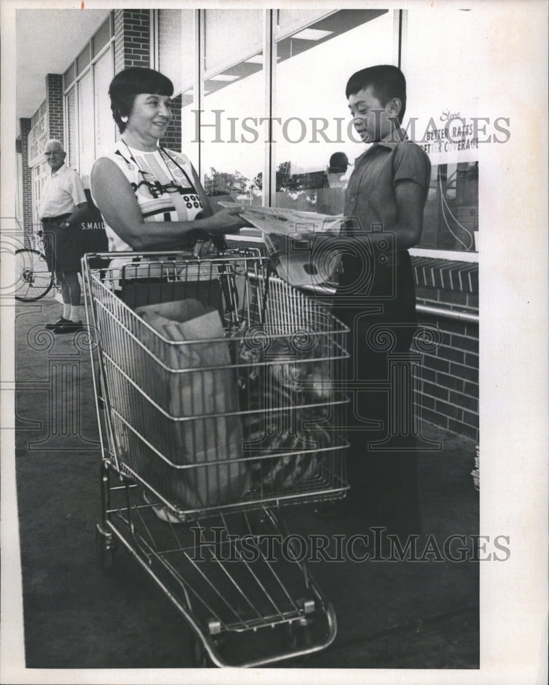 1973 Newsboy Hands Paper to Customer  - Historic Images