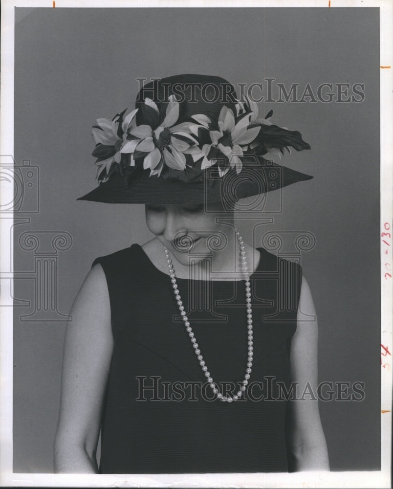 1969 Betty Wagner model a floral bonnet. - Historic Images