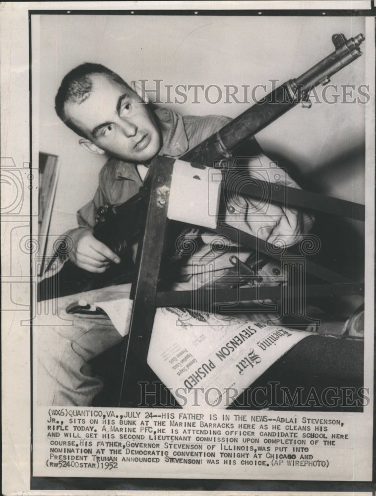 1952 Adlai Stevenson Jr. cleaning his rifle  - Historic Images