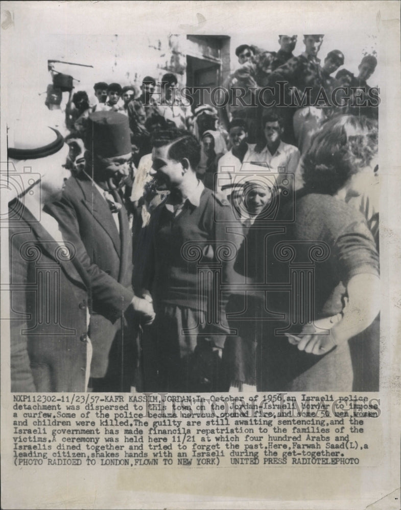 1957 Farwah Saad shakes hands with an Israeli during a get - Historic Images