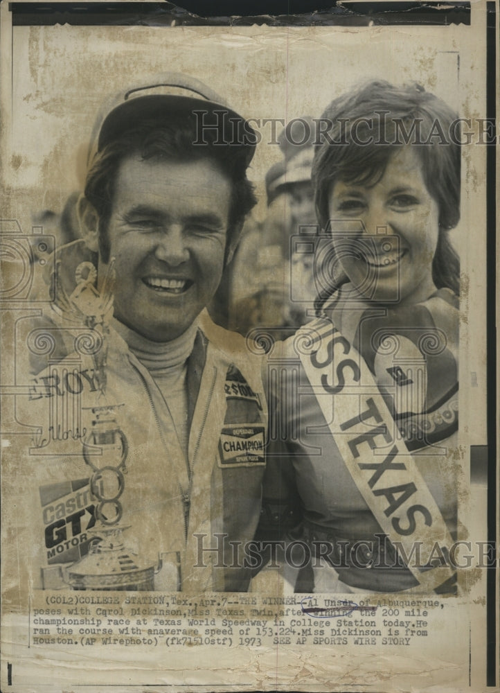 1973 Al Unser poses with Miss Texas Twin. - Historic Images