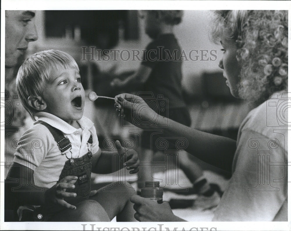 1988 Tricia Cziesla babysitter. Bunky Lanas blowing bubbles. - Historic Images