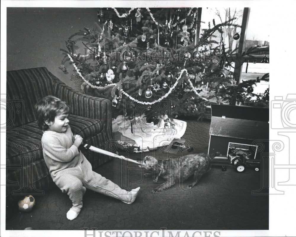 1980 Robbie Frost Plays With Poodle on Christmas Day - Historic Images