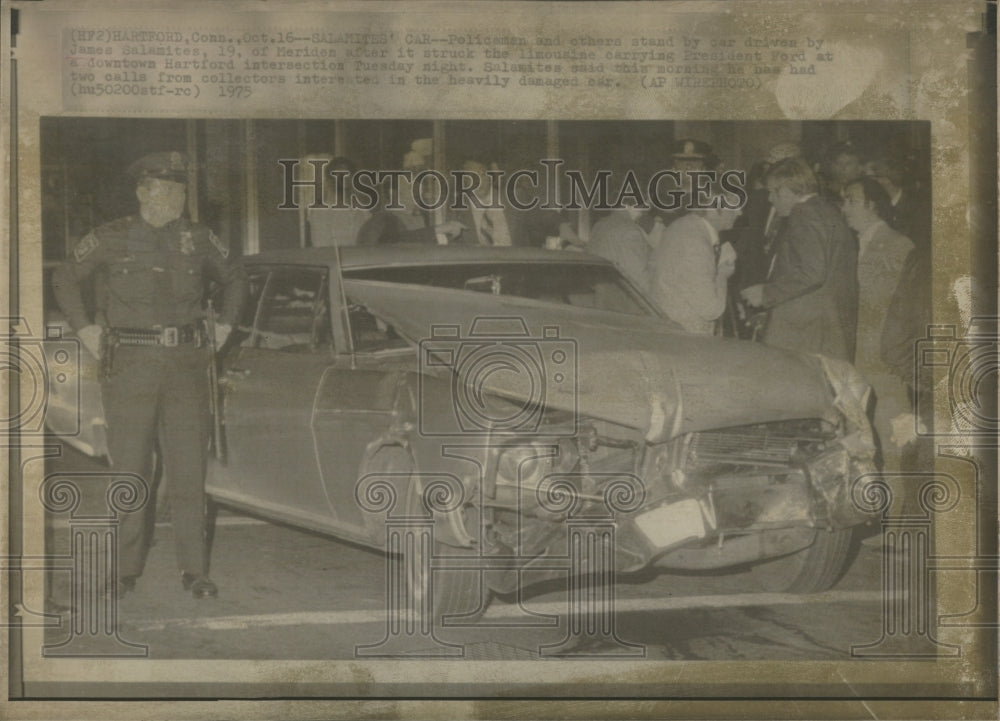 1975 Policemen stand near James Salamites&#39; car after accident - Historic Images