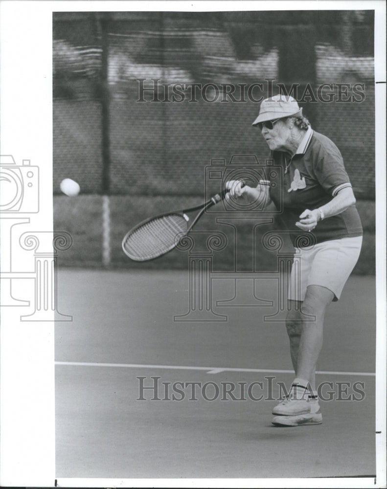 1989 Senior playing tennis, at Senior Fun Day in Highlander Park. - Historic Images