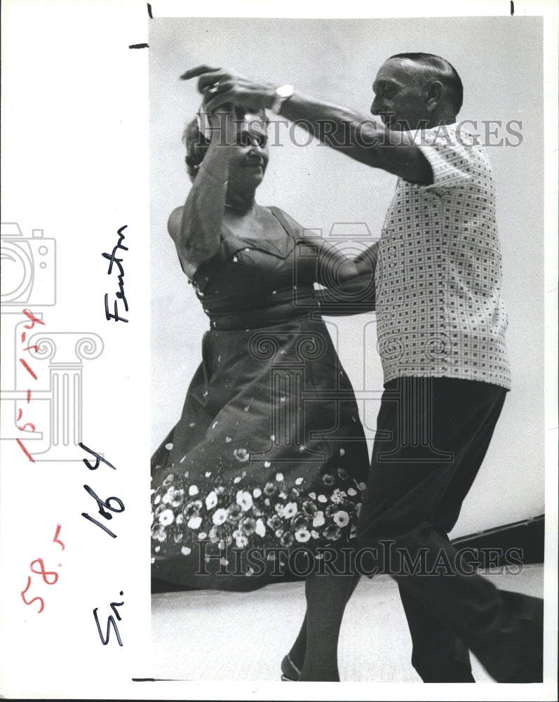 1980 John and Mary Van Veenendaal in ballroom dancing demonstration. - Historic Images