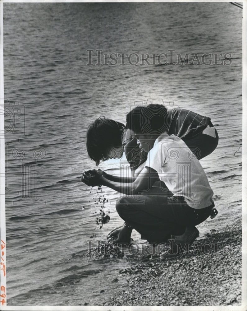 1975 Two youth explore shells island in Citrus Country.  - Historic Images