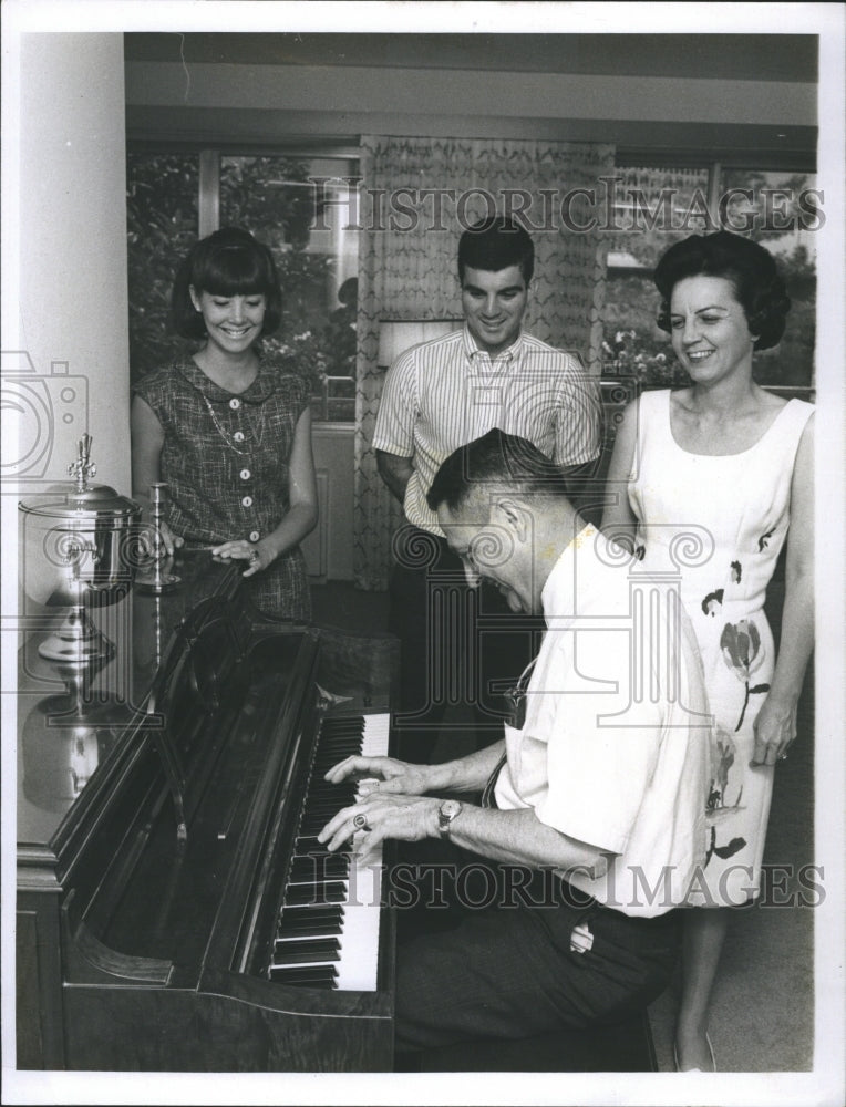 1965 Rep.James Pickle of Texas plays piano with her family. - Historic Images