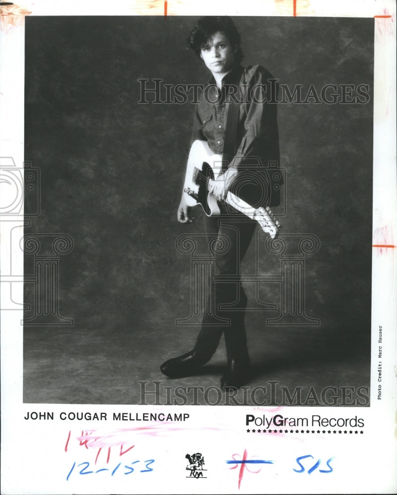 1986 John Cougar Mellencamp posing with his guitar.  - Historic Images