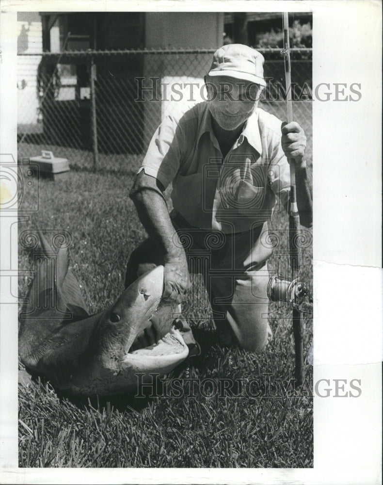 1980 Charles Whetre with the tiger shark he caught. - Historic Images
