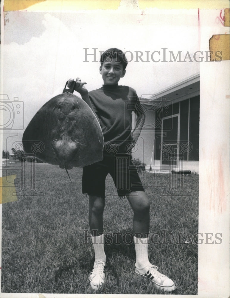 1972 Mike Mlynski displays a butterfly ray he caught from his - Historic Images