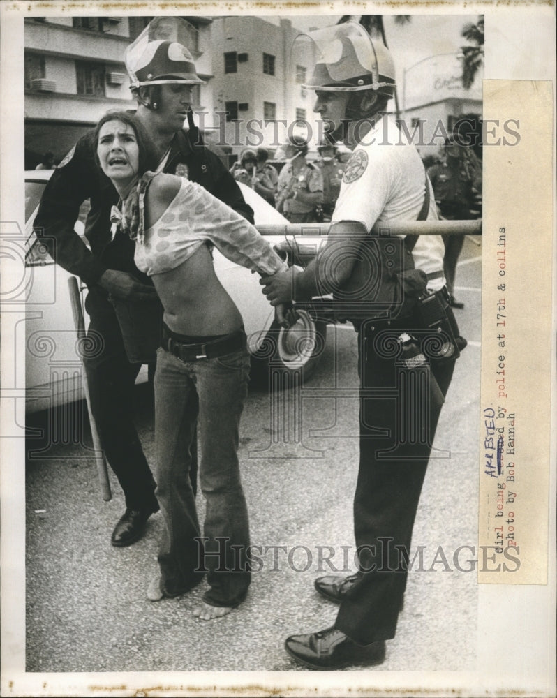 1972 A girl being arrested by police  - Historic Images