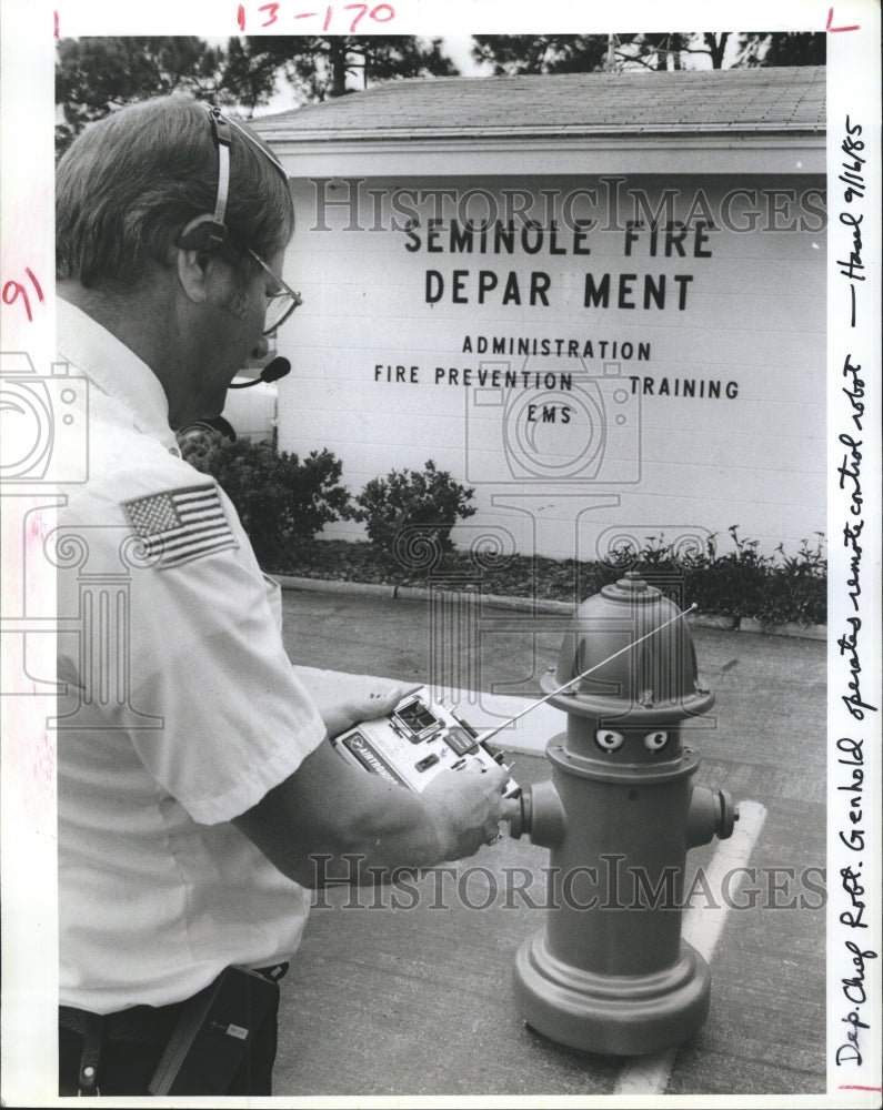 1985 Robert Genhold controlling hydrant robot named "Pluggie" - Historic Images