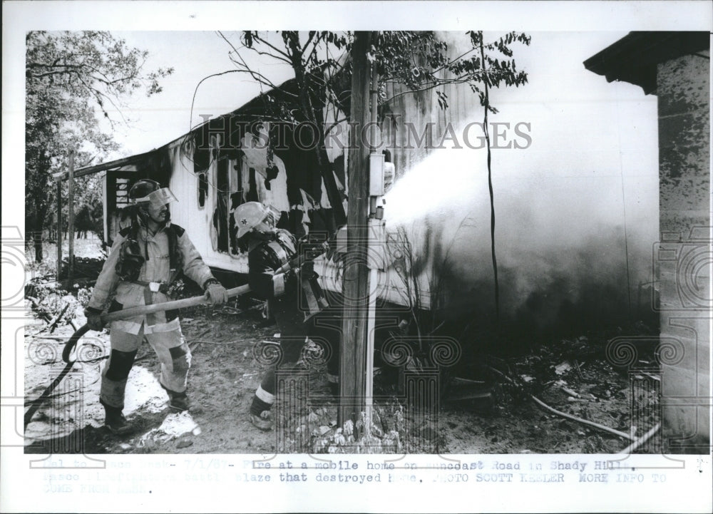 1987 Fire fighters battle a mobile home fire on Suncoast Road in - Historic Images