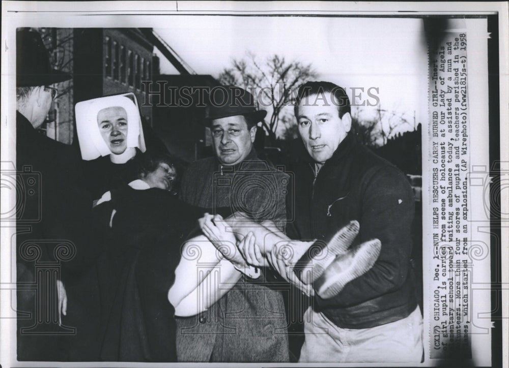 1958 A girl is carried from scene - Historic Images