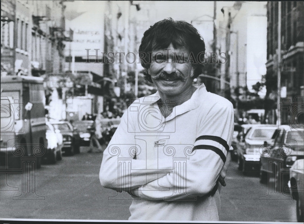 1977 Man standing in very crowded street.  - Historic Images