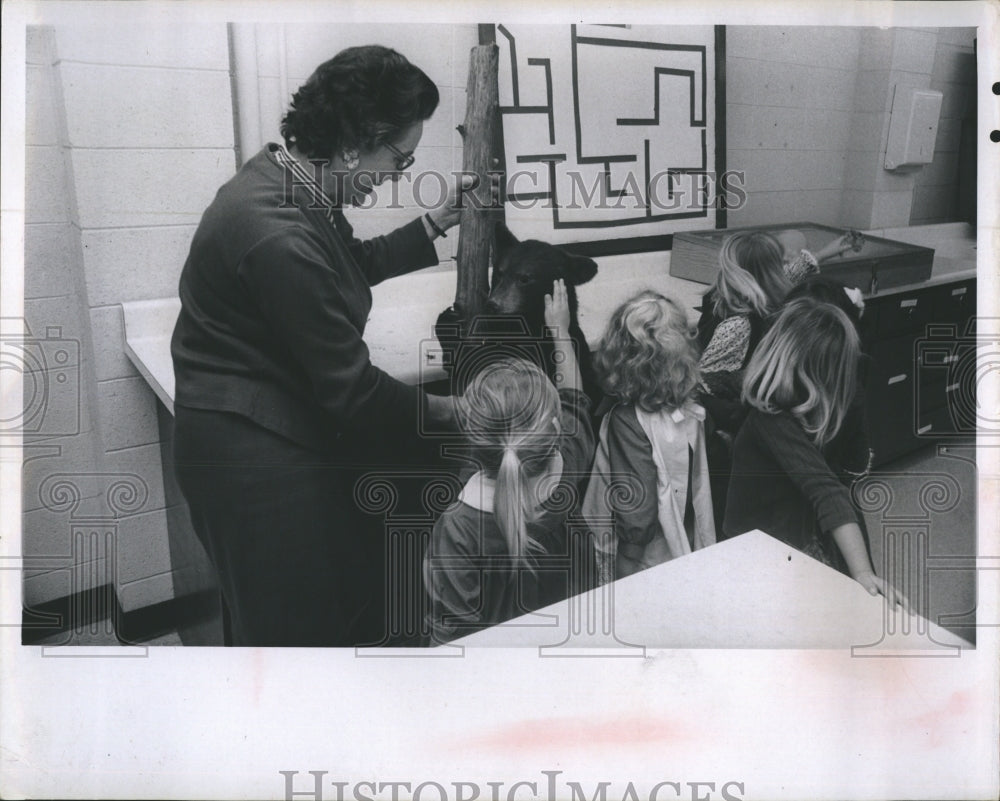 1967 Youngster petting the stuffed teddy bear.  - Historic Images