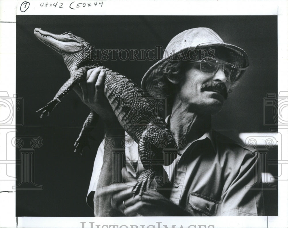 1988 John Moulton Holding a 1 year old Alligator - Historic Images