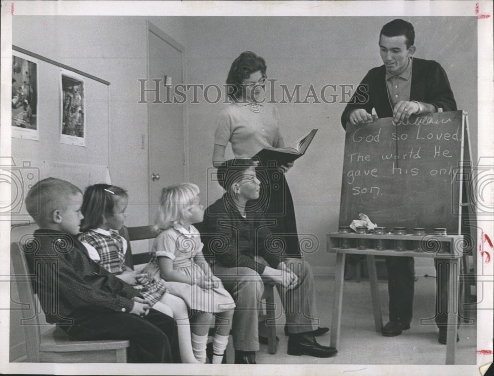 1961 Teaching Sunday School, passage in the bible. - Historic Images