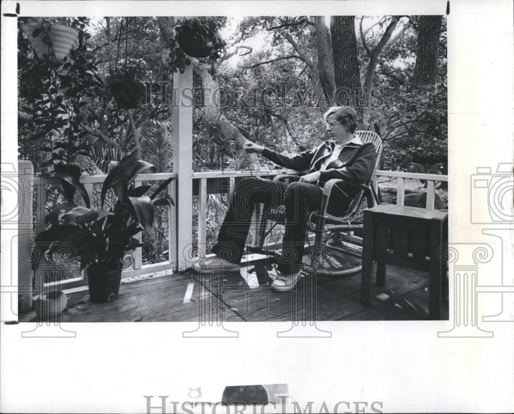 1977 Tim Meinke, 14 sits on the Meinke's upstairs porch - Historic Images