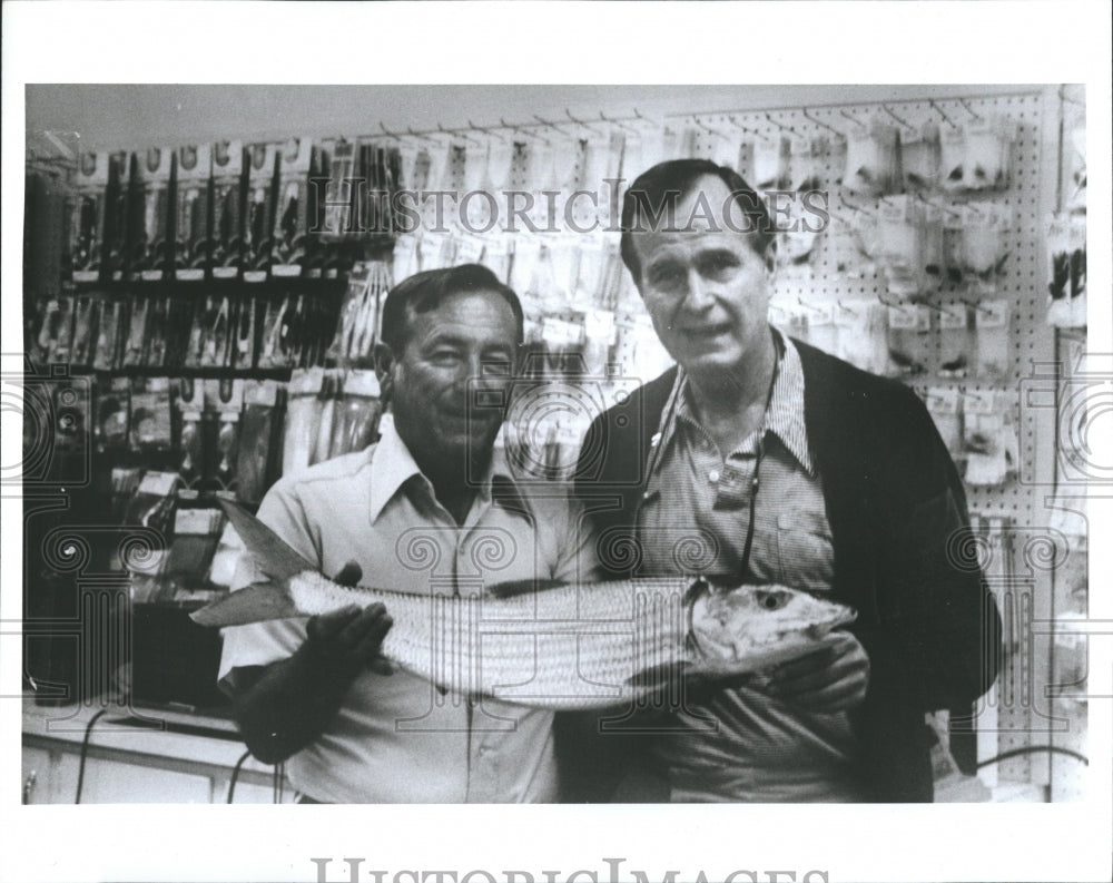 George Bush holding a fish.  - Historic Images