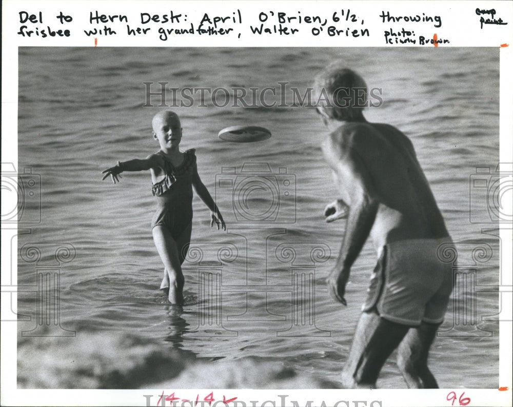 1985 April O'Brien play catch with Walter O'Brien - Historic Images