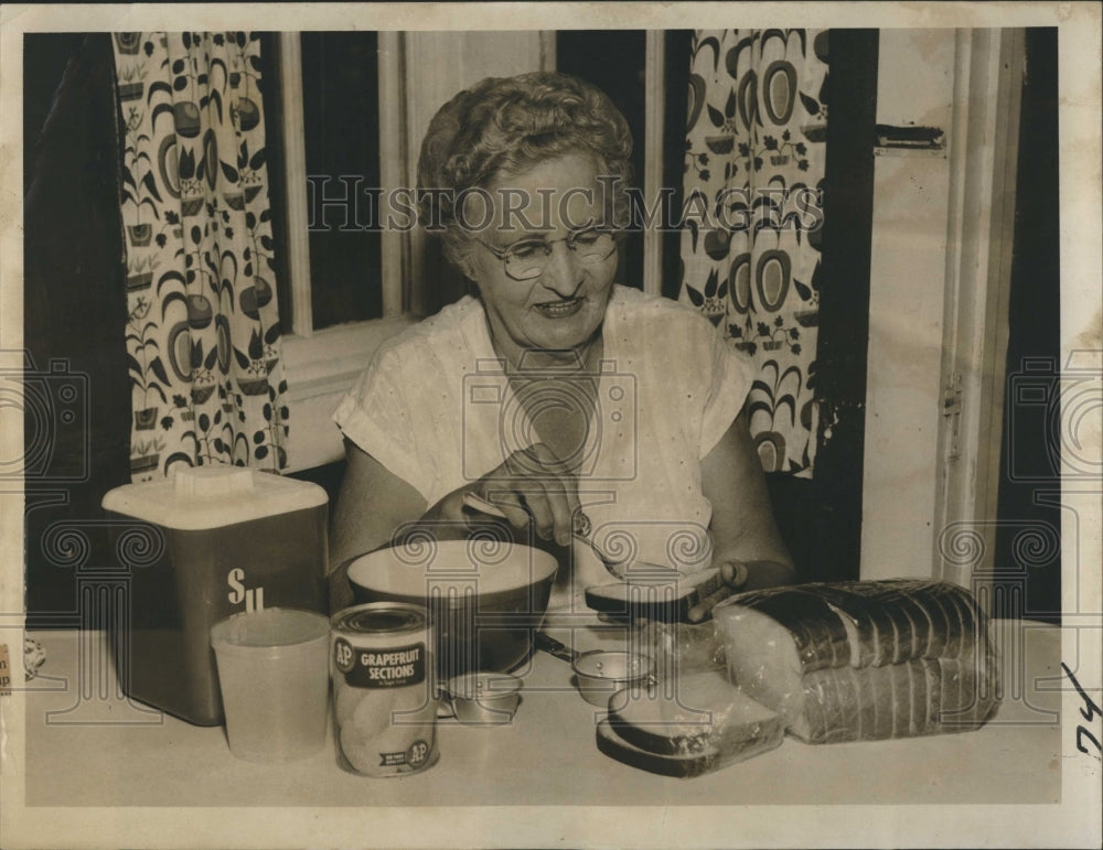 1955 Mrs. Laura Mullin makes Angel Fruit recipe. - Historic Images