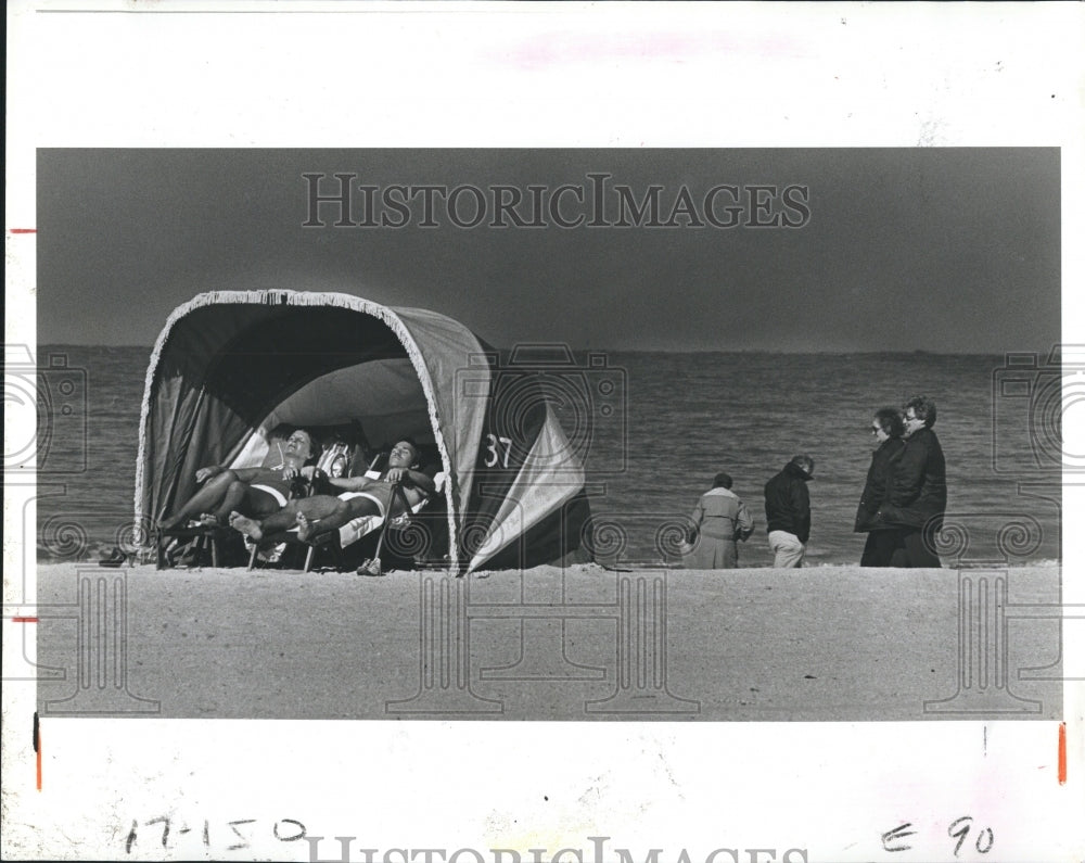 1981 People in Swimsuits, Overcoats at Clearwater Beach Florida - Historic Images