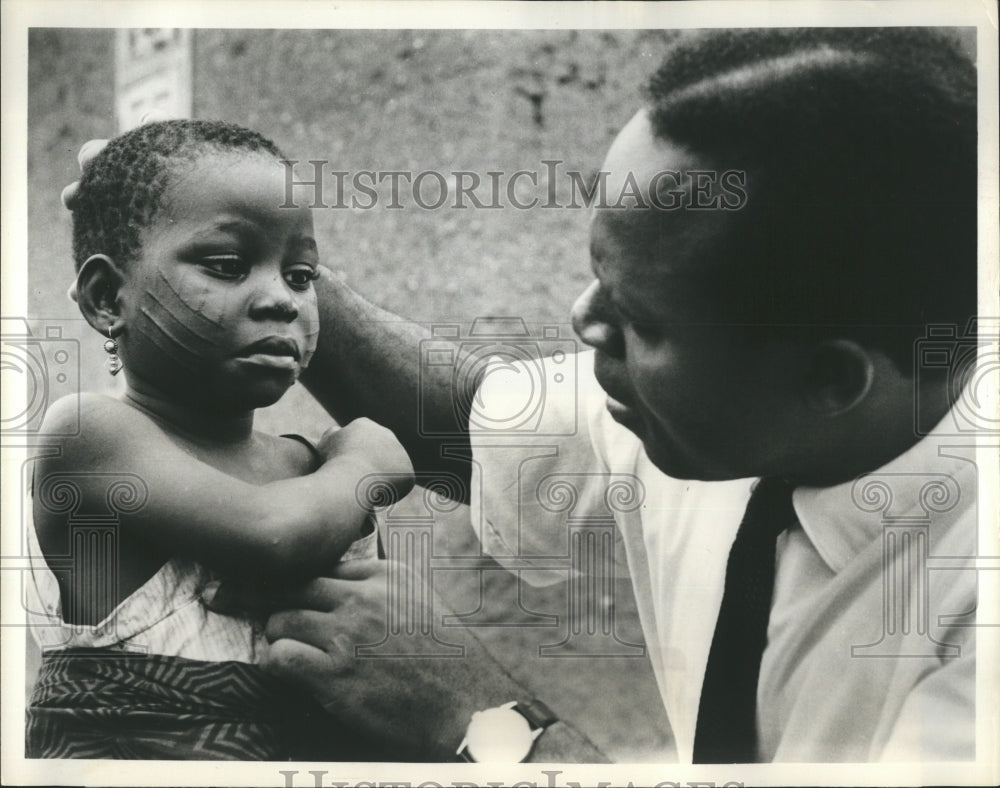 1963 Rockefeller Foundation Doctor Examining Little Girl in Nigeria - Historic Images