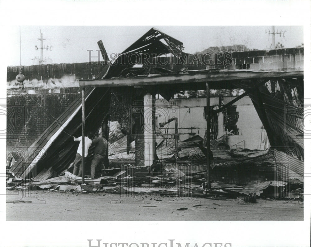 1982 Fire Marshall inspect debris of fire at Hillsborouh Country.. - Historic Images